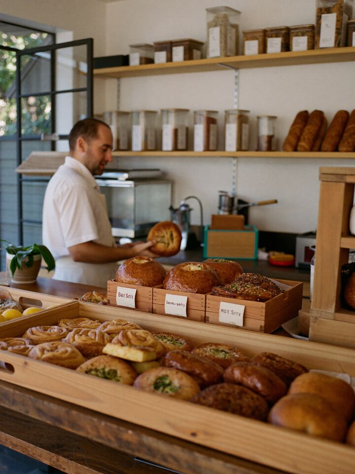 Baker with fresh bread and pastries