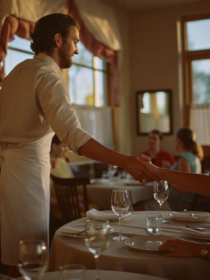 Restaurant owner welcoming guests